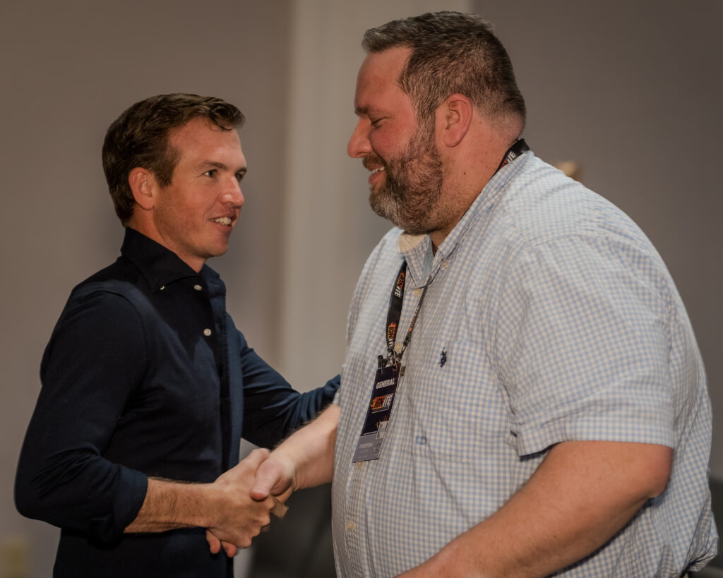 wo professionals shaking hands while actively listening and engaging in conversation