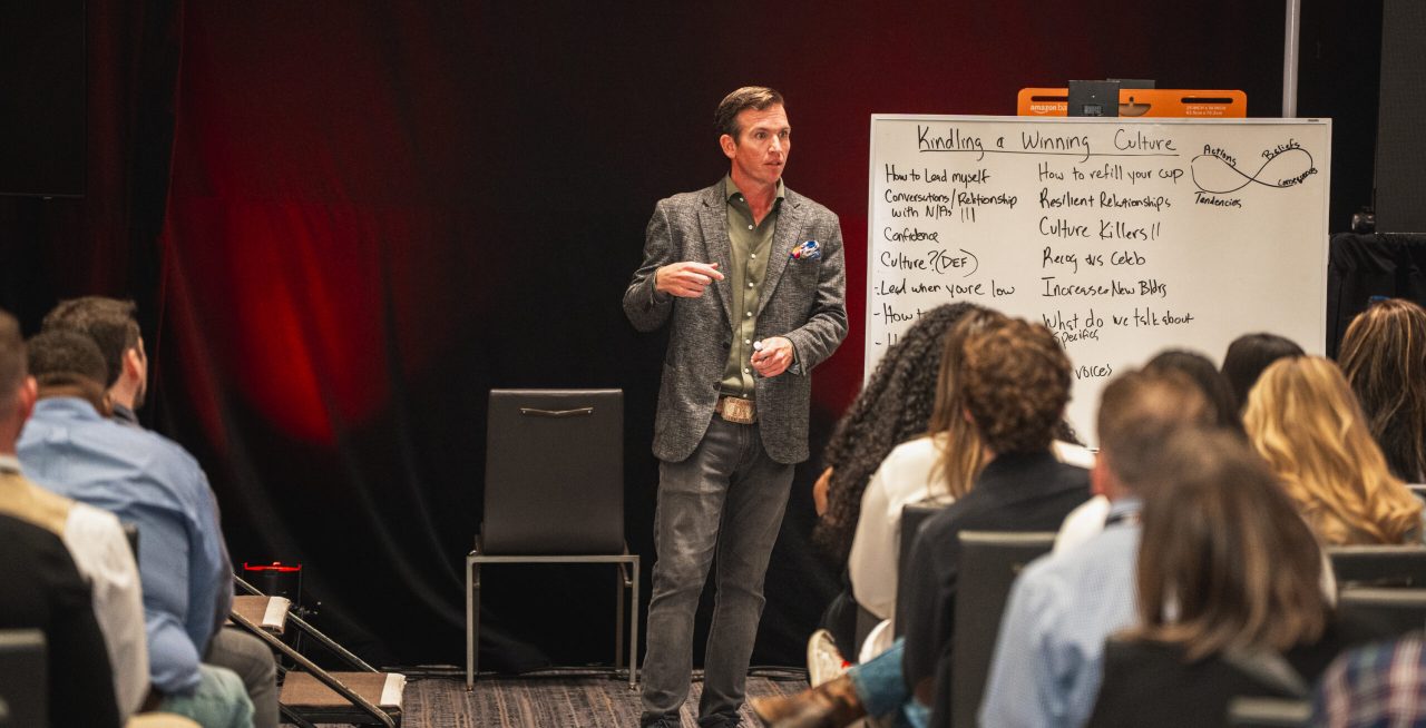 Speaker delivering a leadership workshop on building a winning culture