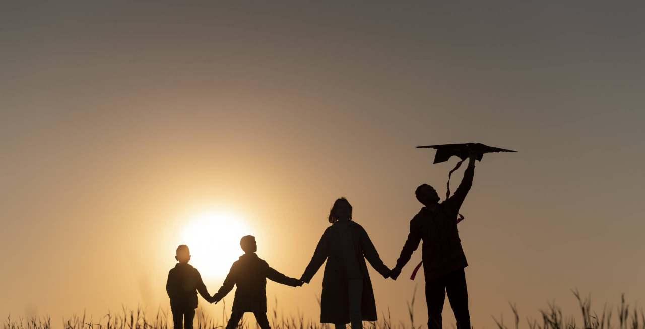 full-shot-family-silhouette-having-fun-sunset-min