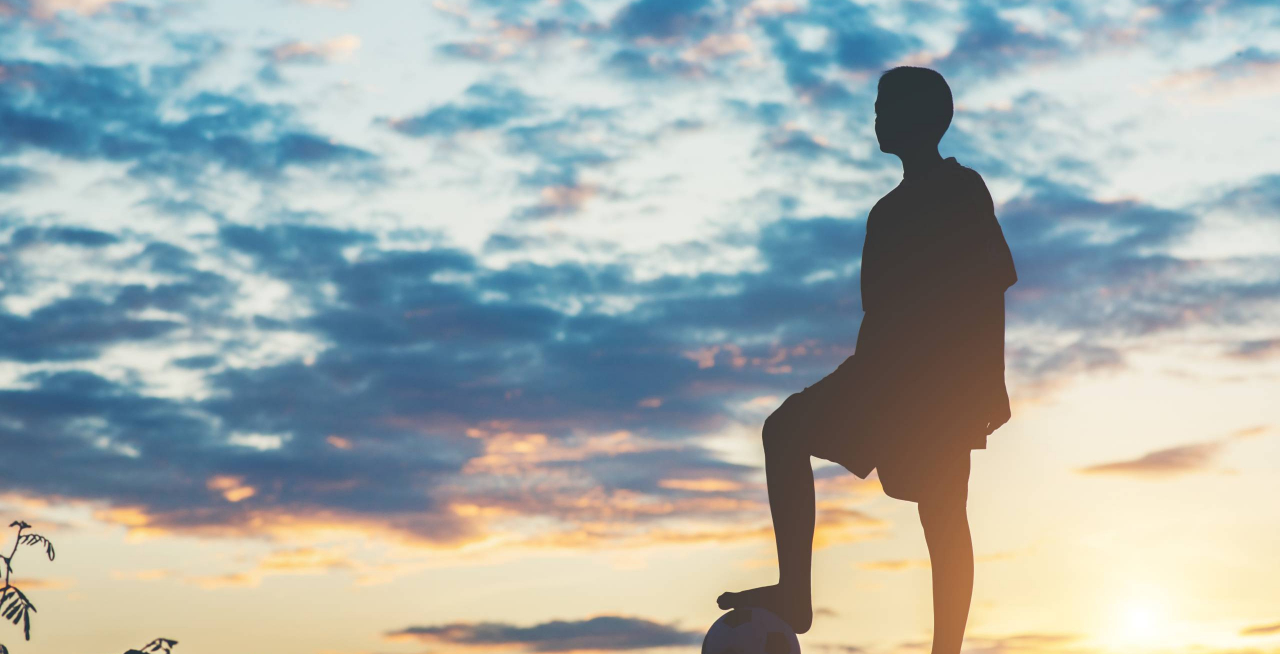 Silhouette of children play soccer football